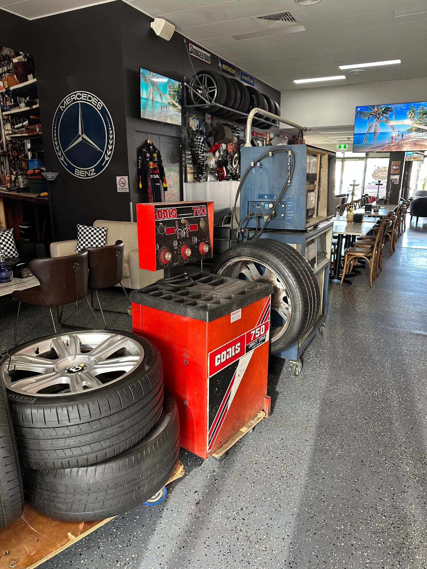 Coats 750 tyre balancer and wheels beside the dining area